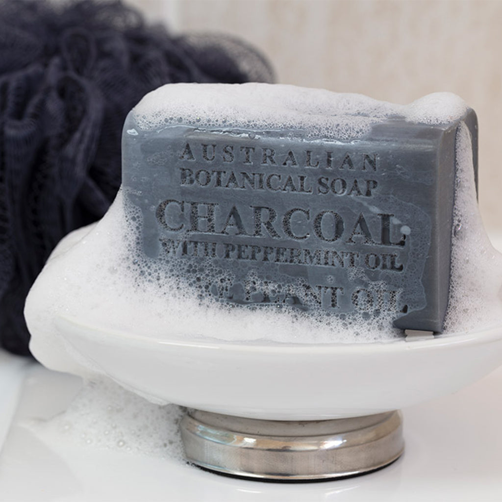 Bar of Australian Botanical Soap with Peppermint Oil on a white soap dish.