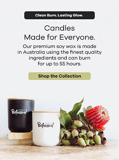Two candles on a wooden surface with text about premium soy wax candles made in Australia.