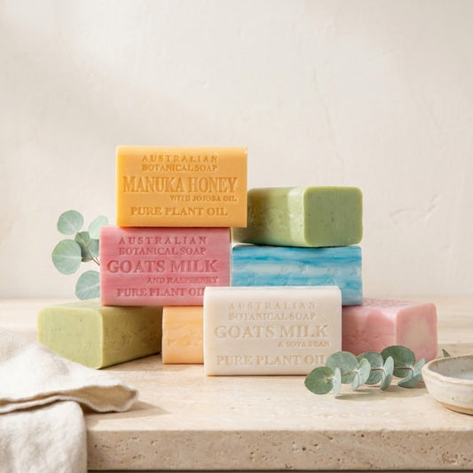 Australian Botanical Soap bars on a stone surface with eucalyptus leaves and linen.