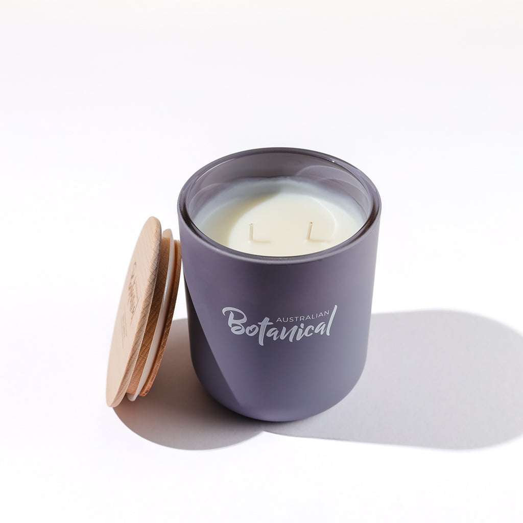 Purple candle with wooden lid on a white background, featuring 'Australian Botanical' branding.