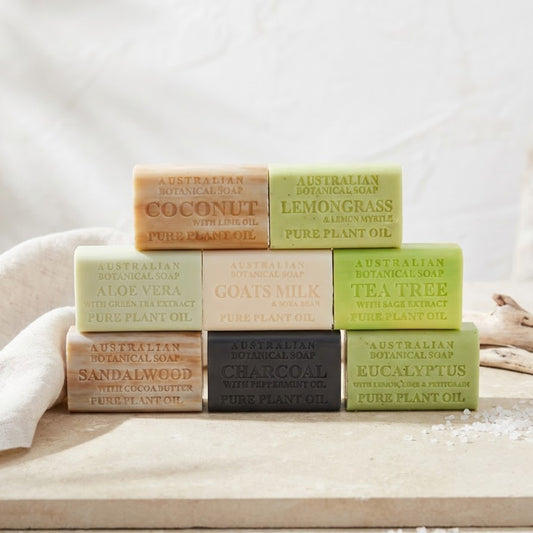 Assorted Australian botanical soaps on a wooden surface with a white background