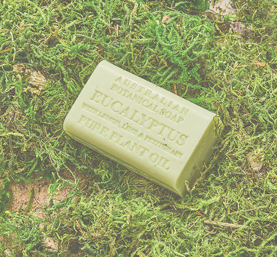 Bar of soap with text on a green moss background