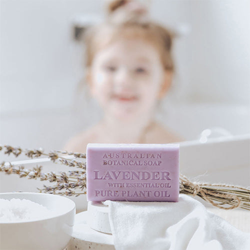 Lavender soap bar with lavender sprigs and child in the background