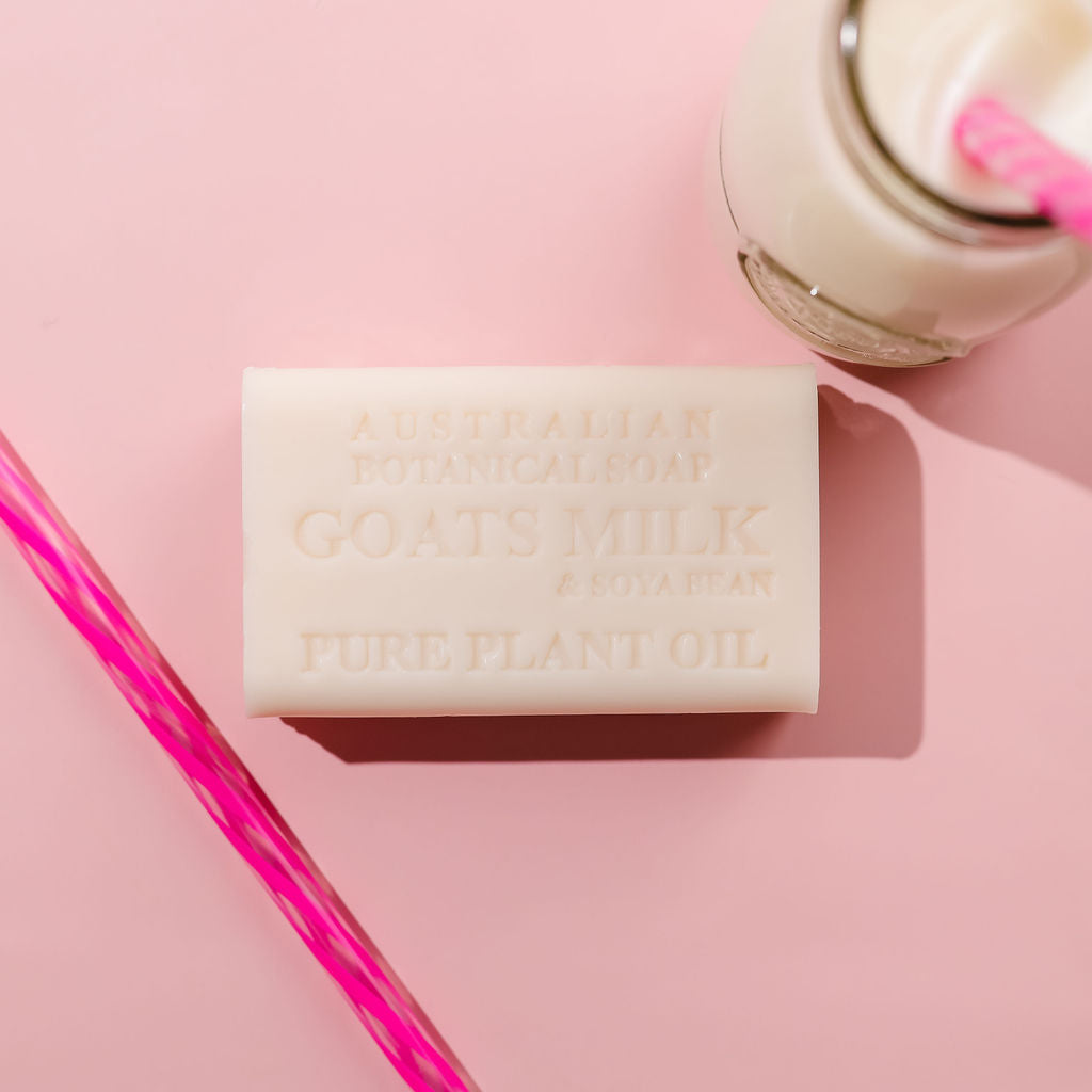 Bar of soap with 'Goats Milk' and 'Pure Plant Oil' text on a pink background