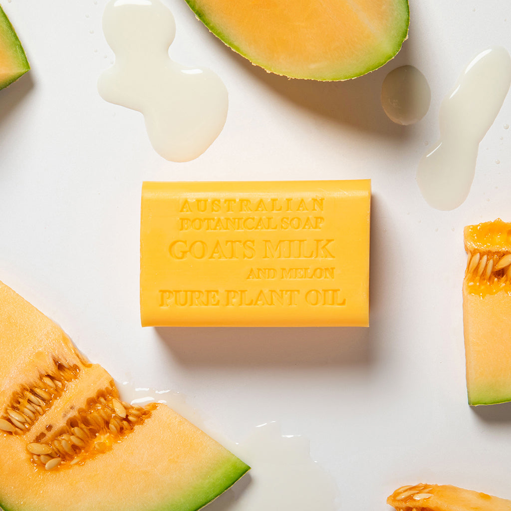 Bar of Australian botanical soap with goat's milk and melon on a white background