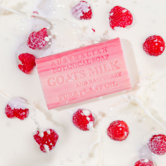 Bar of Australian Botanical Soap with Goats Milk and Raspberry on a white background with raspberries.