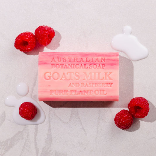 Bar of Australian Botanical Soap with raspberries on a light background