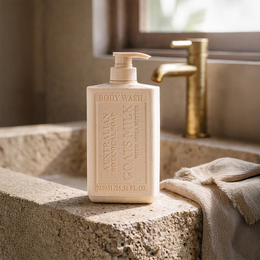 Body wash bottle on a stone surface with a towel and faucet in the background