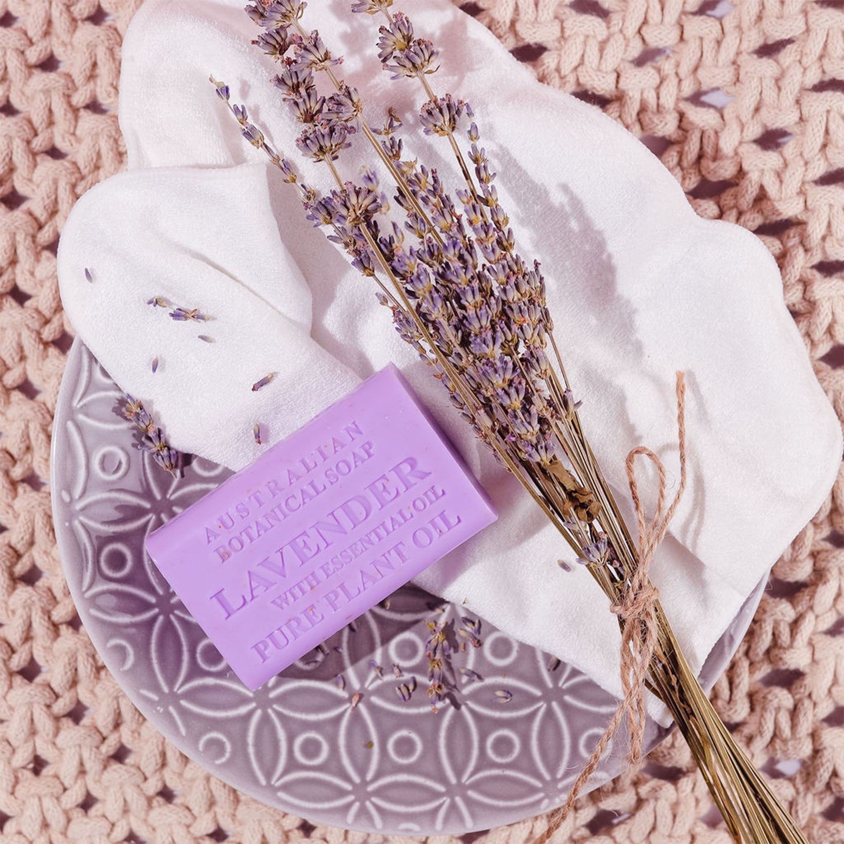Lavender soap bar with a bar of Australian Botanical Lavender soap on a textured surface.