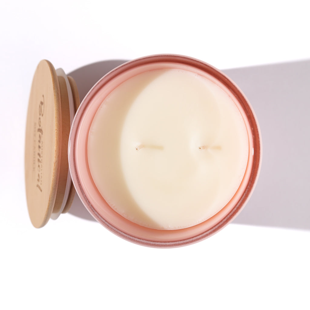 Candle in a tin with a wooden lid on a white background