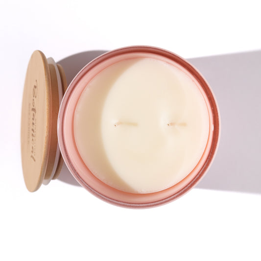 Candle in a tin with a wooden lid on a white background