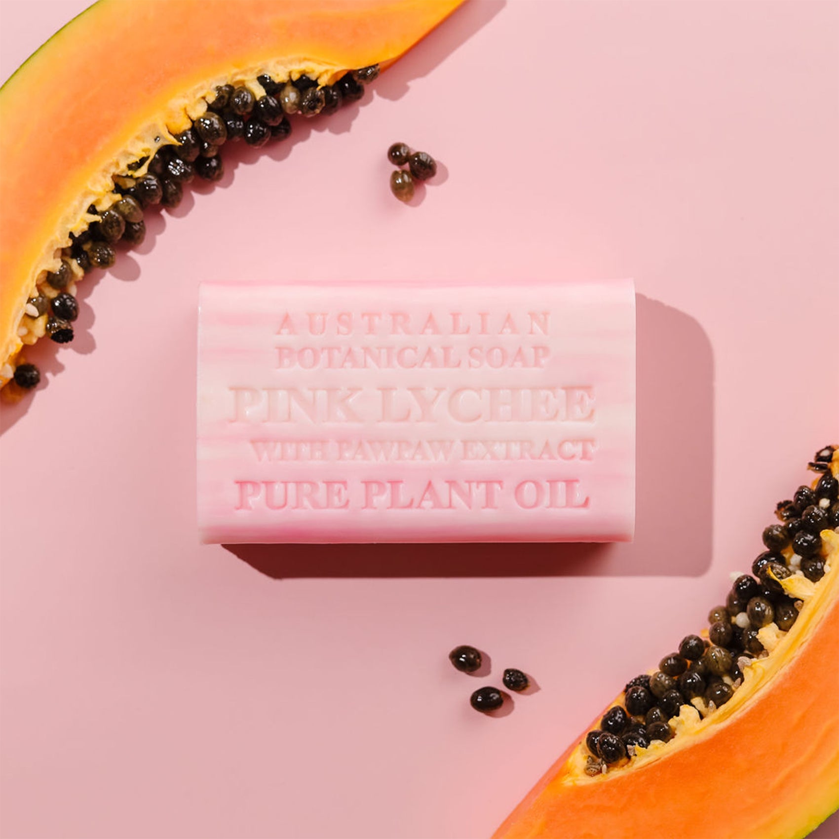 Pink soap bar with 'Australian Botanical Soap' text on a pink background with papaya slices.