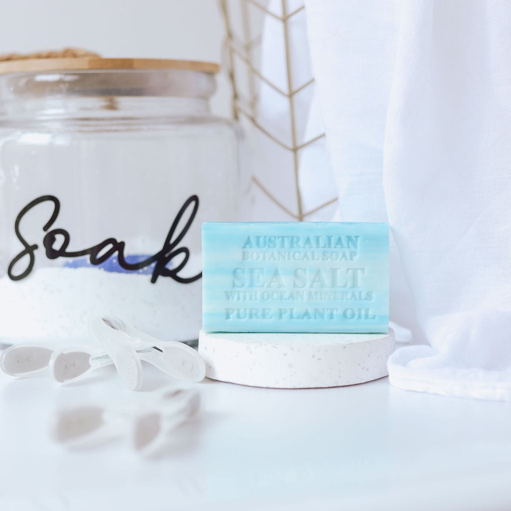 Jar labeled 'Soak' with a bar of soap on a white surface