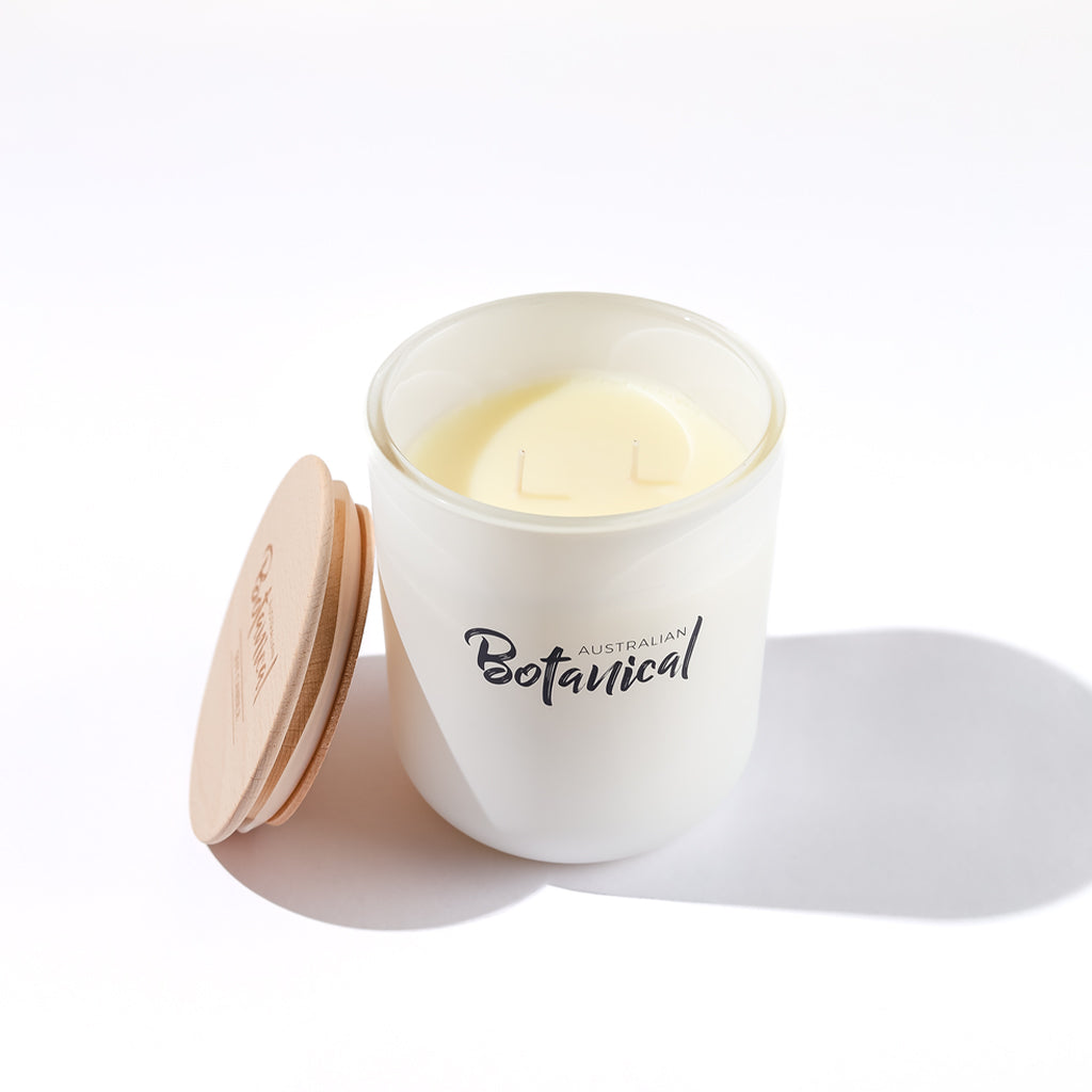 White candle in a jar with 'Australian Botanical' branding on a white background