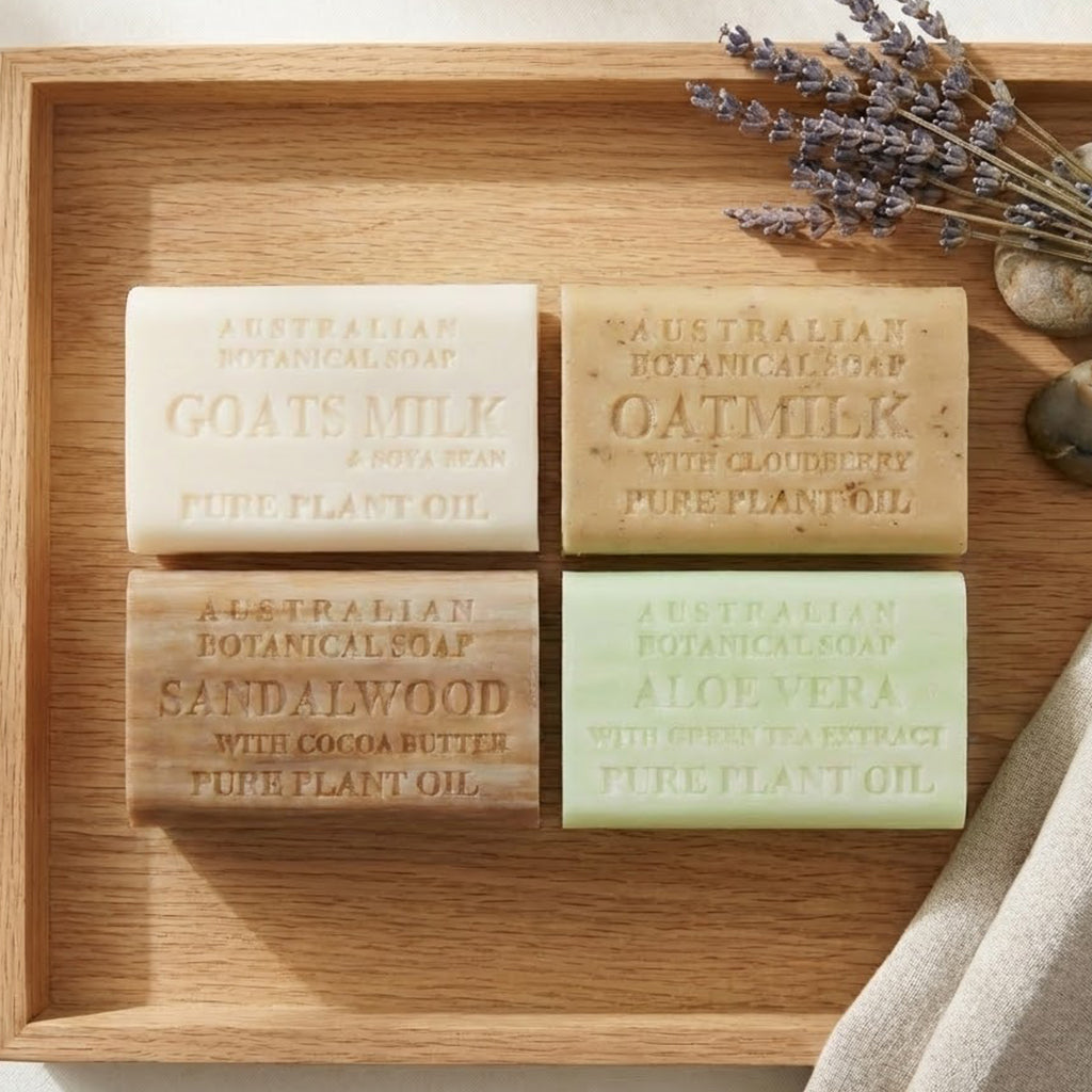 Four Australian Botanical Soap bars on a wooden try with stones and lavender.