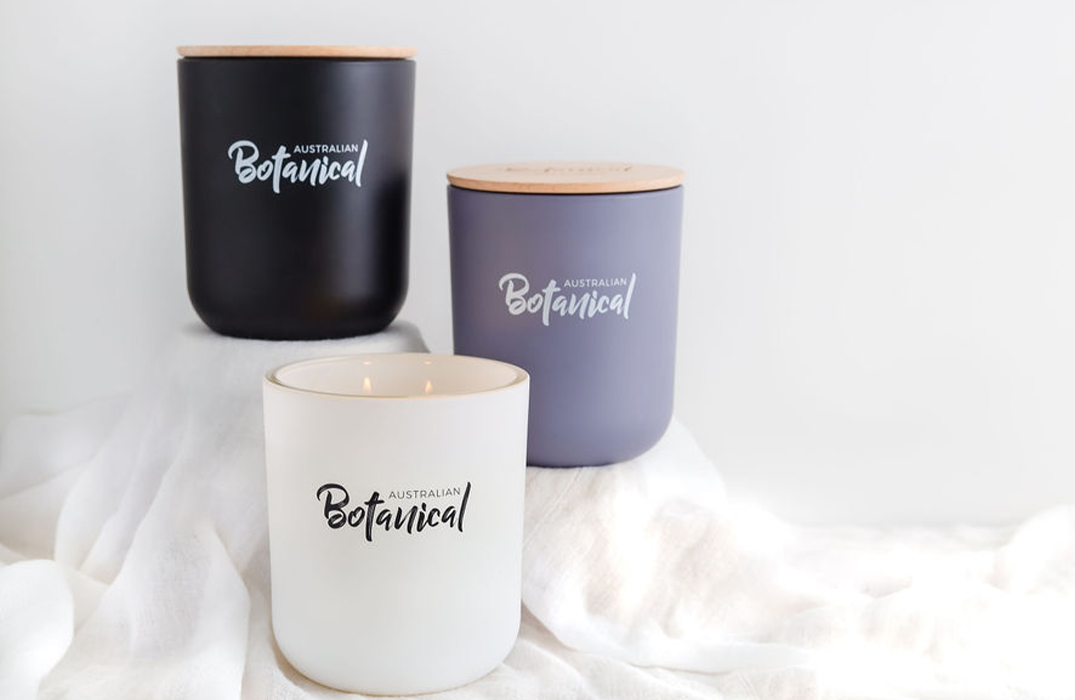 Vanilla Caramel, Coconut and Lime, and Sweet Sandalwood Soy Candles on a table